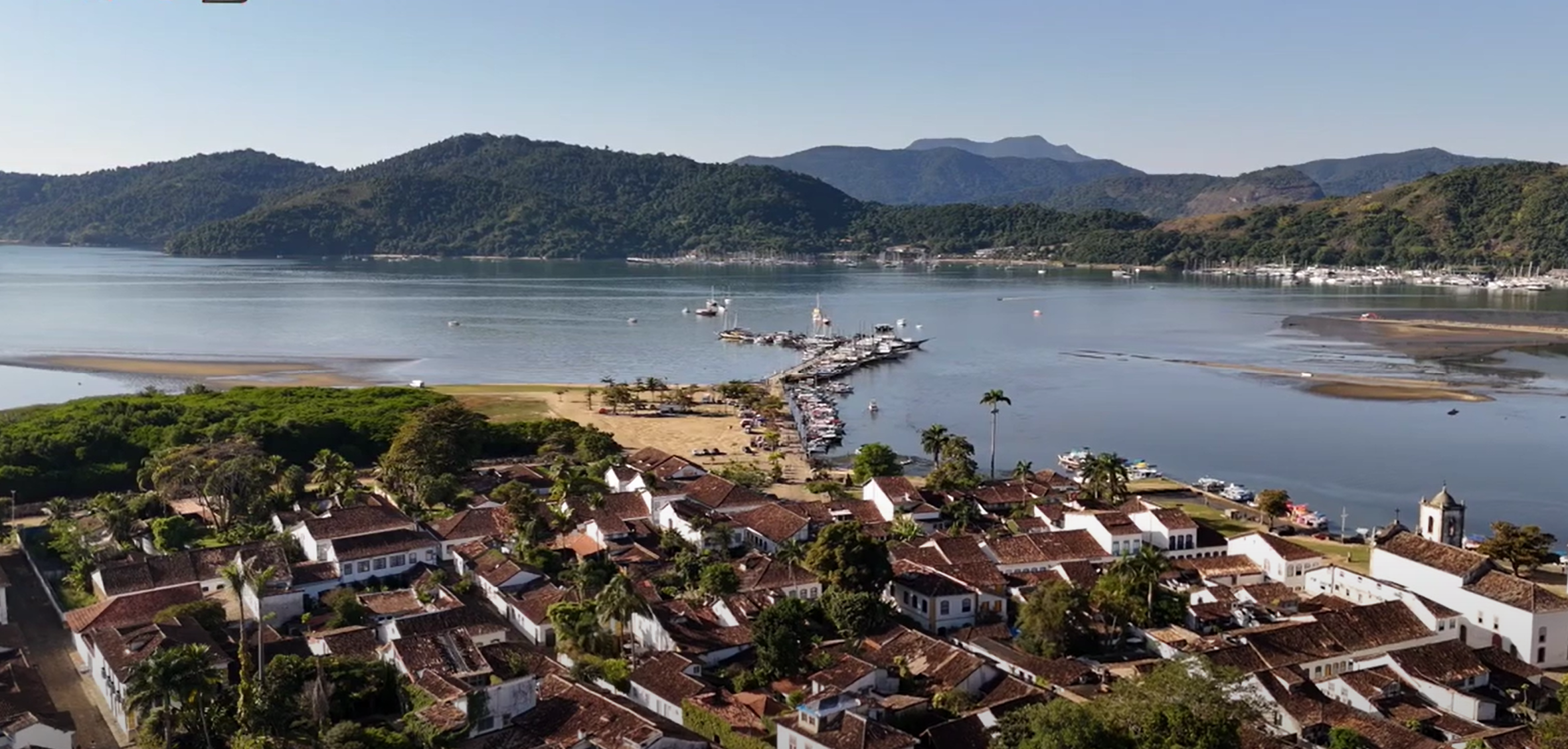 Vista panorâmica da baía de Paraty com ilhas, praias e mar azul cristalino — destino de veleiro na Costa Verde.
